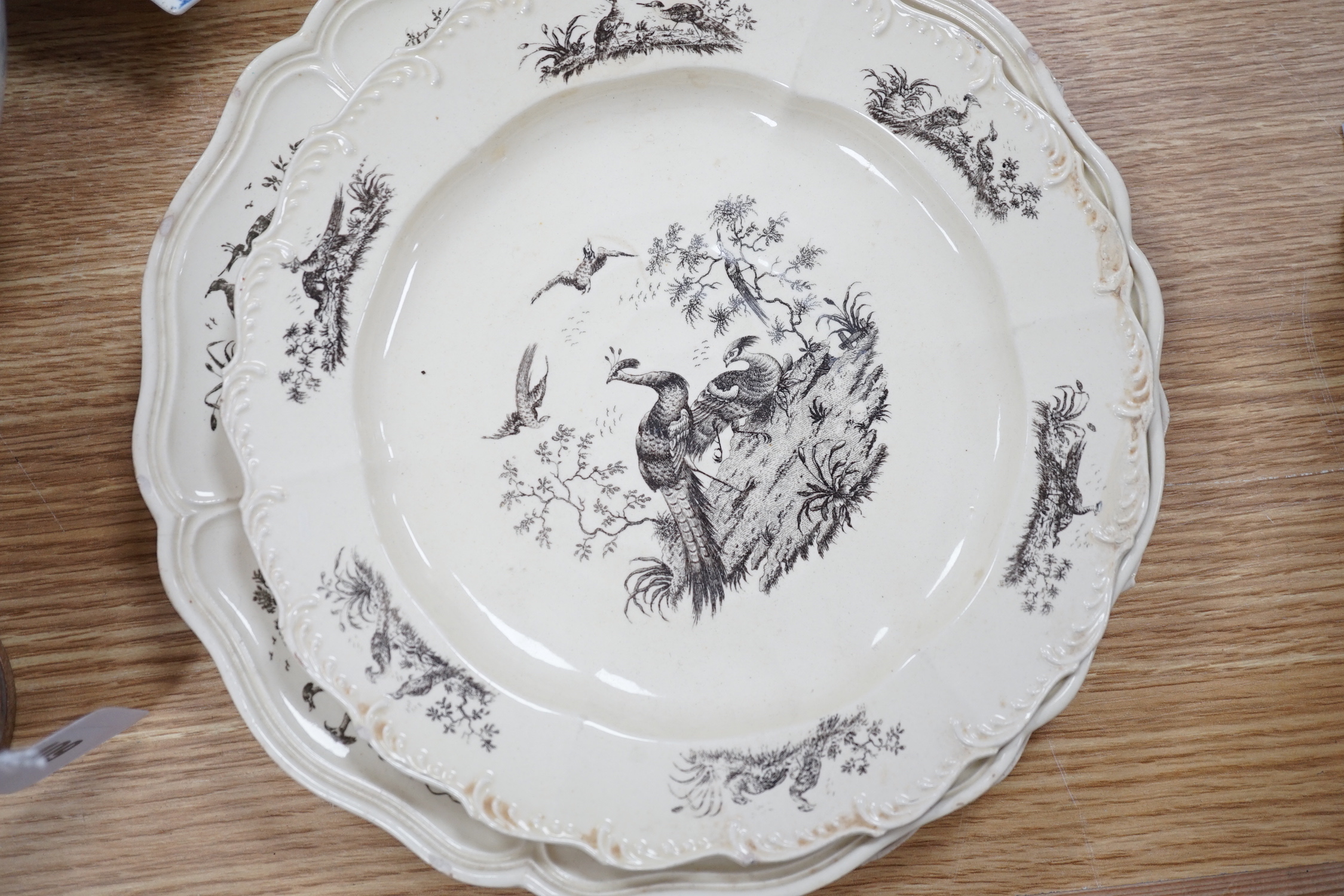 A collection of late 18th/early 19th century pearlware and creamware including three black transfer printed creamware plates, c.1780, blue and white bowls, plates, dishes and jug, the largest 27cm in diameter
